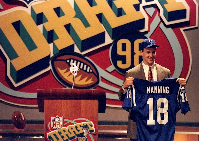 Peyton Manning poses for photos after the Indianapolis Colts drafted him No. 1 overall in 1998. (Photo credit: Jamie Squire/Allsport)